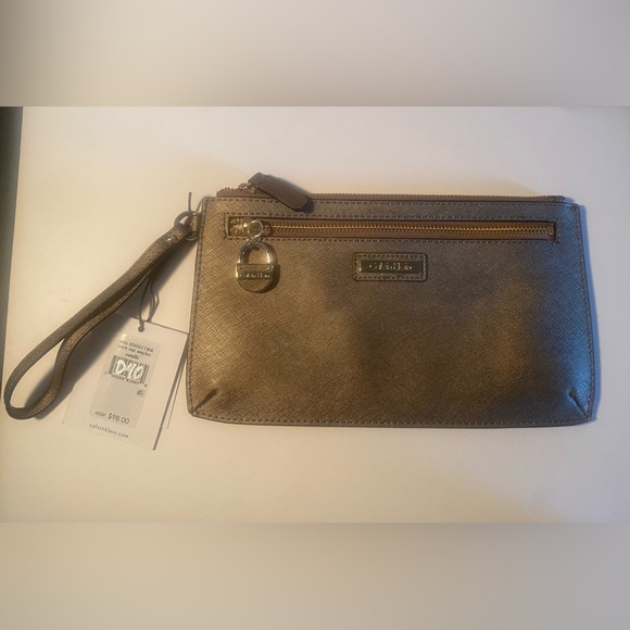 Calvin Klein Handbags - CALVIN KLEIN Wristlet. NEW. Bronze metallic color with Gold hardware.